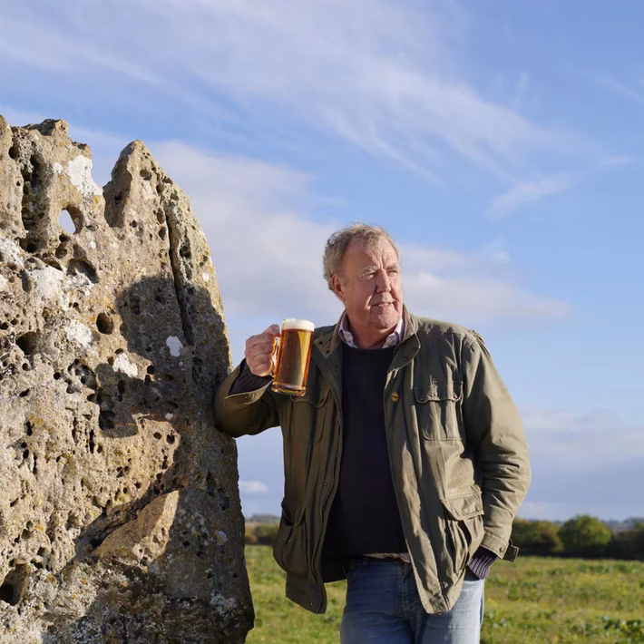Jeremy Clarkson drinking Hawkstone in a field