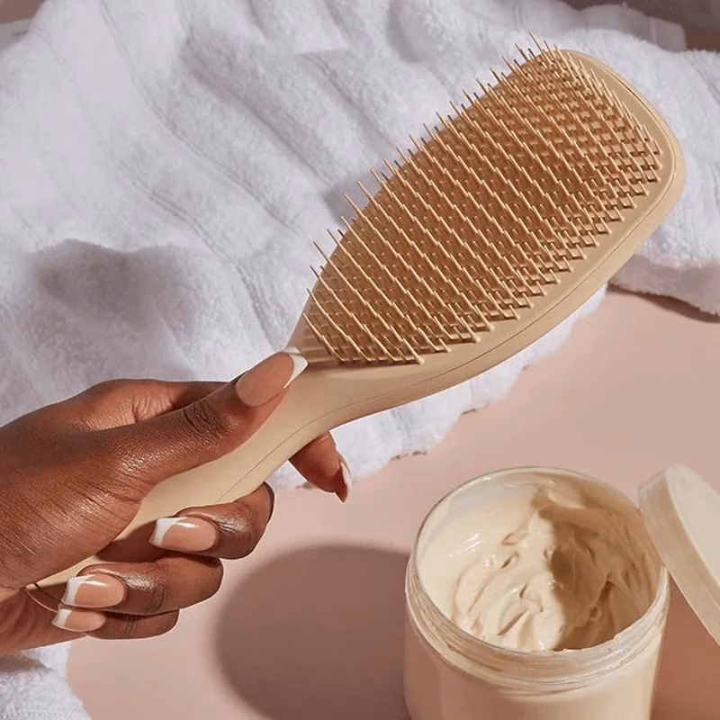 Tangle Teezer hairbrush next to a pot of treatment