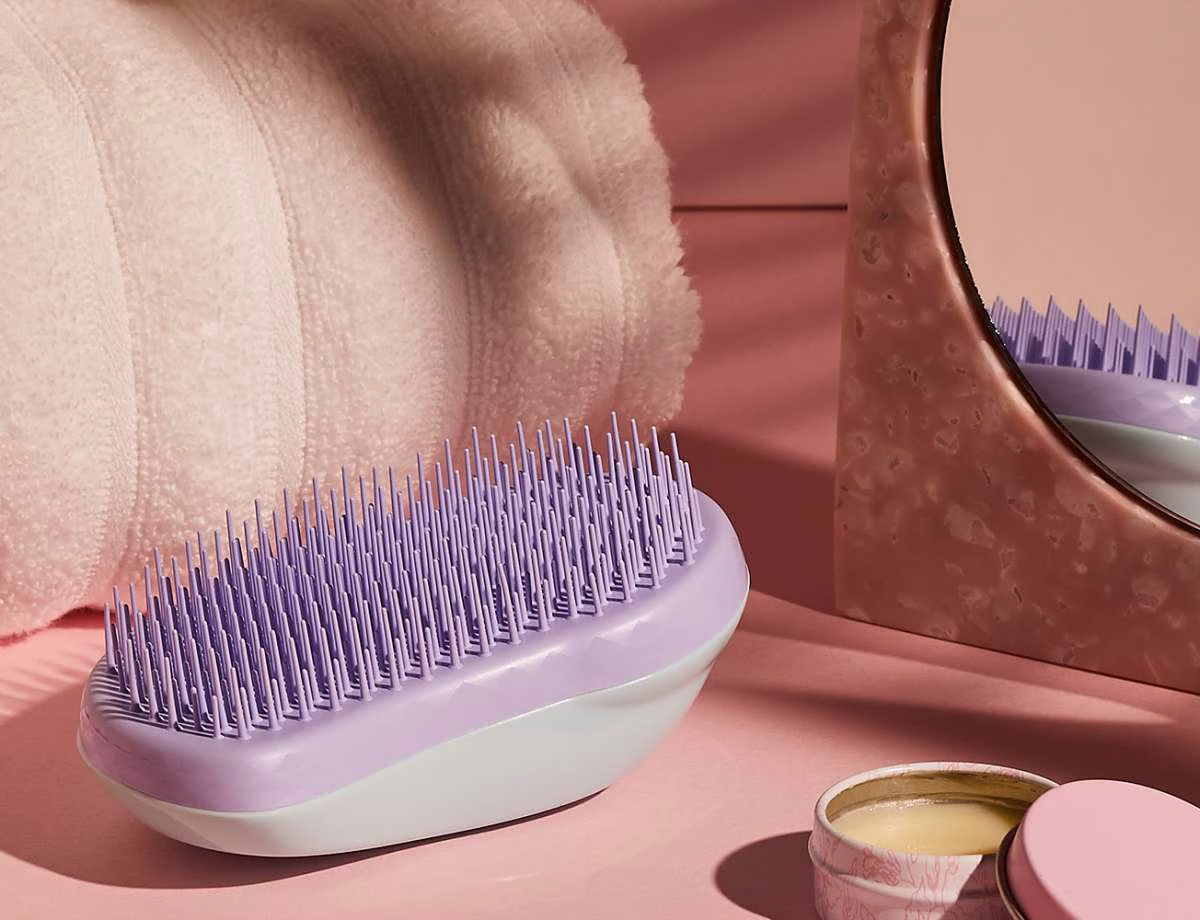 Tangle Teezer hairbrush next to a pot of wax