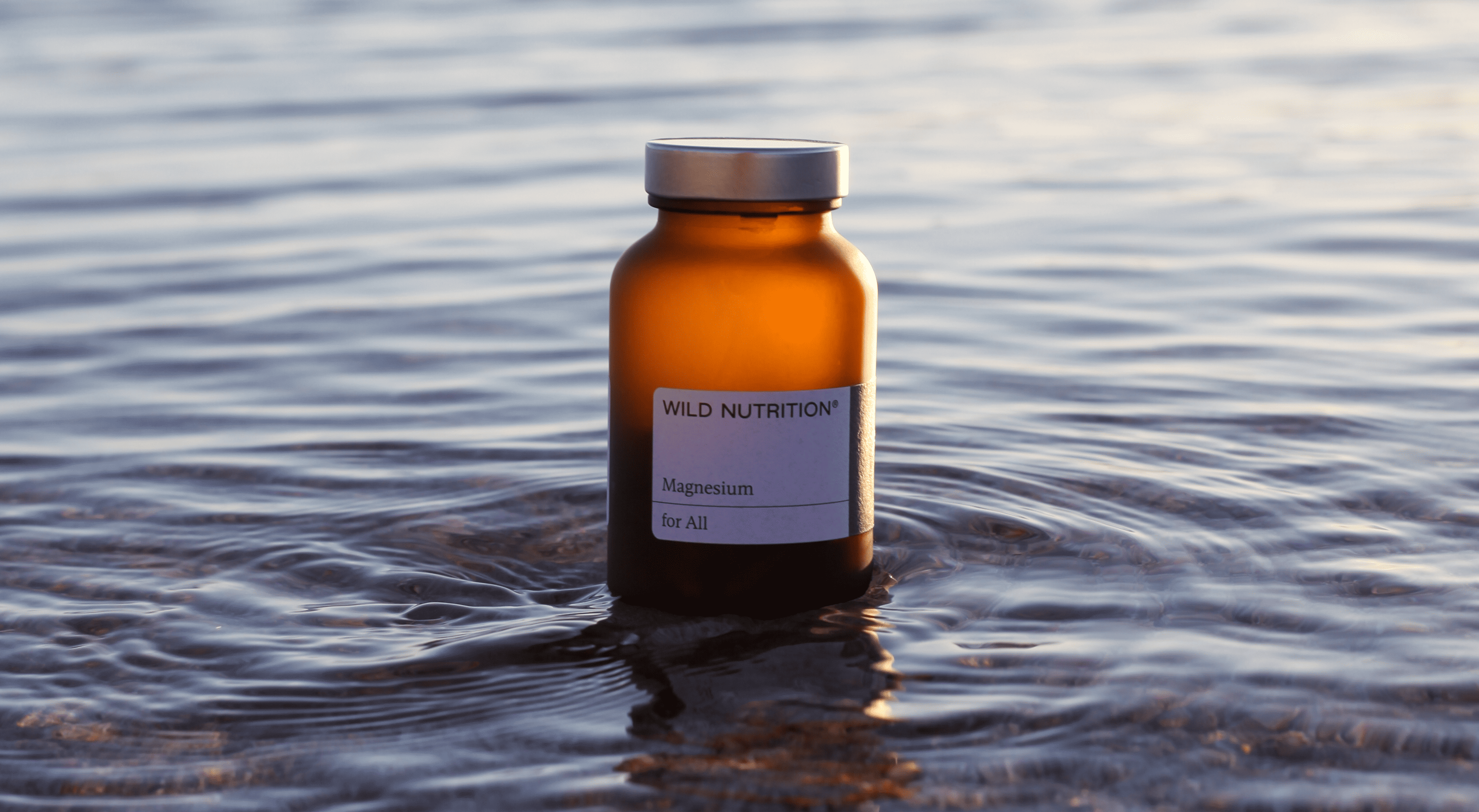 Wild Nutrition supplement bottle in water